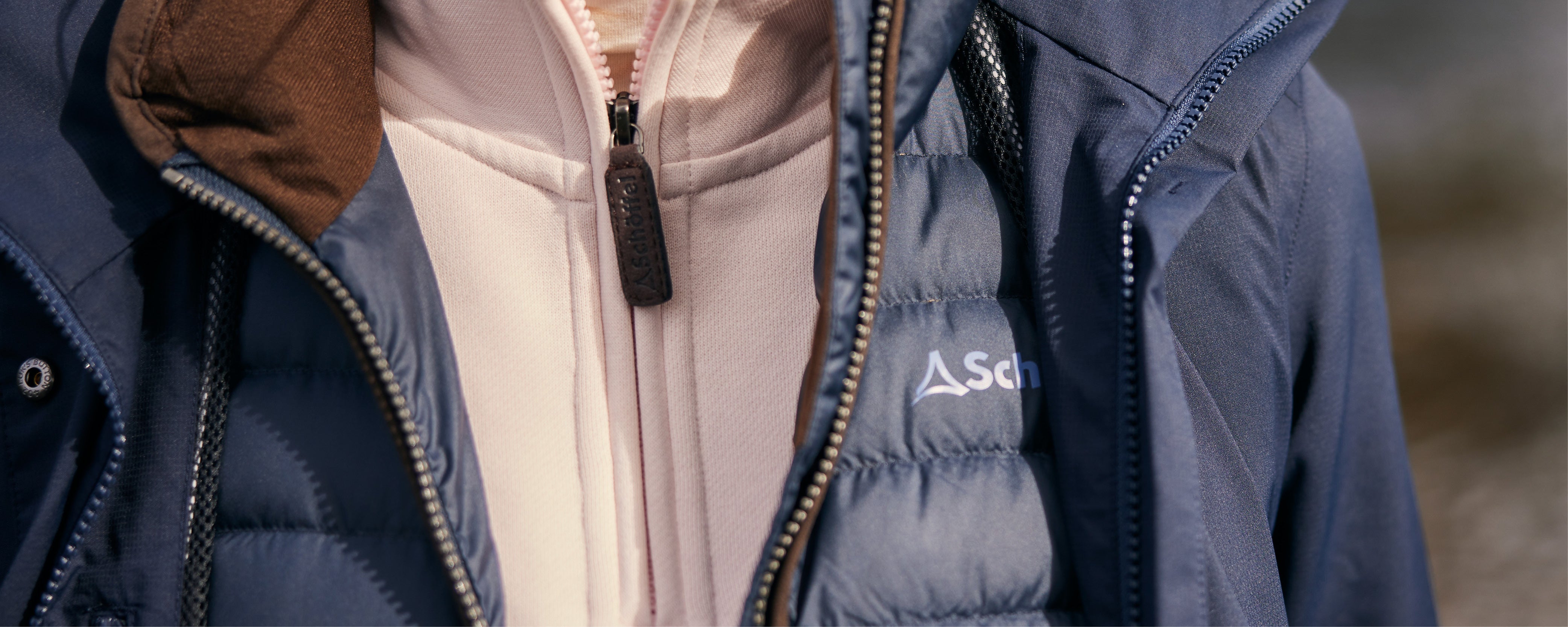 Dark blue quilted puffer jacket with down insulation and subtle chest logo