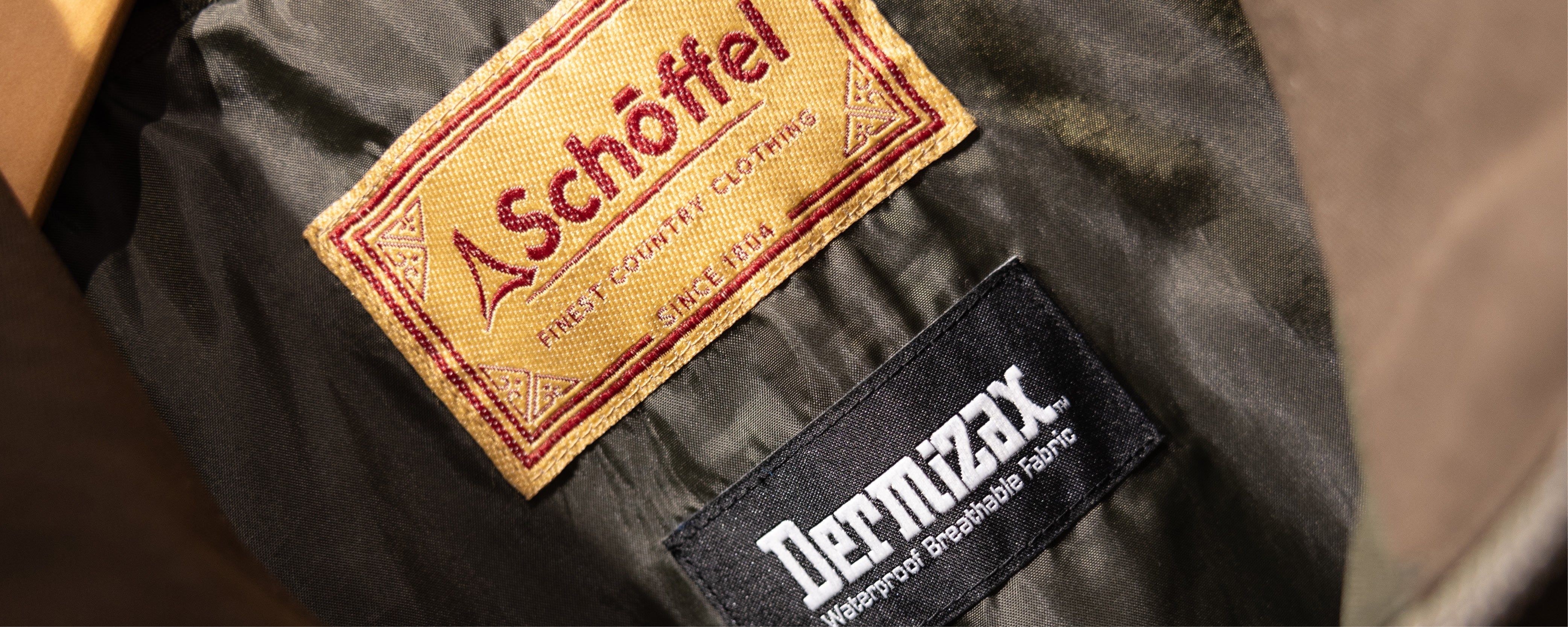 Schoffel embroidered label with red stitching on Toray Dermizax green fabric