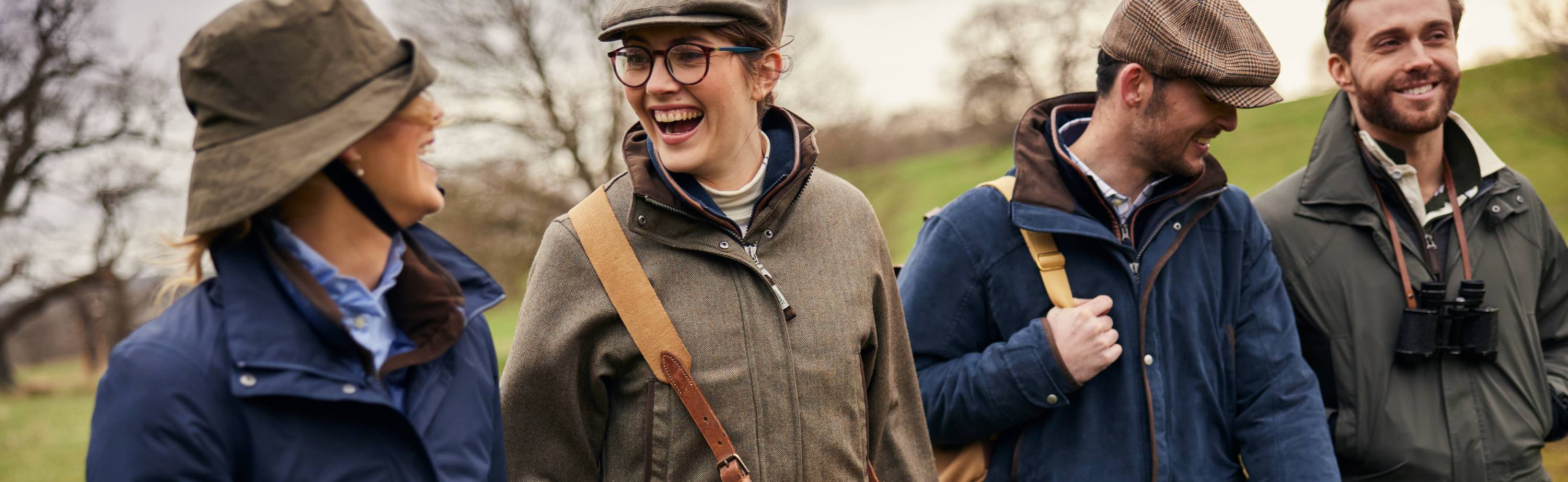 Woman in field jacket wearing brown leather satchel with tan strap