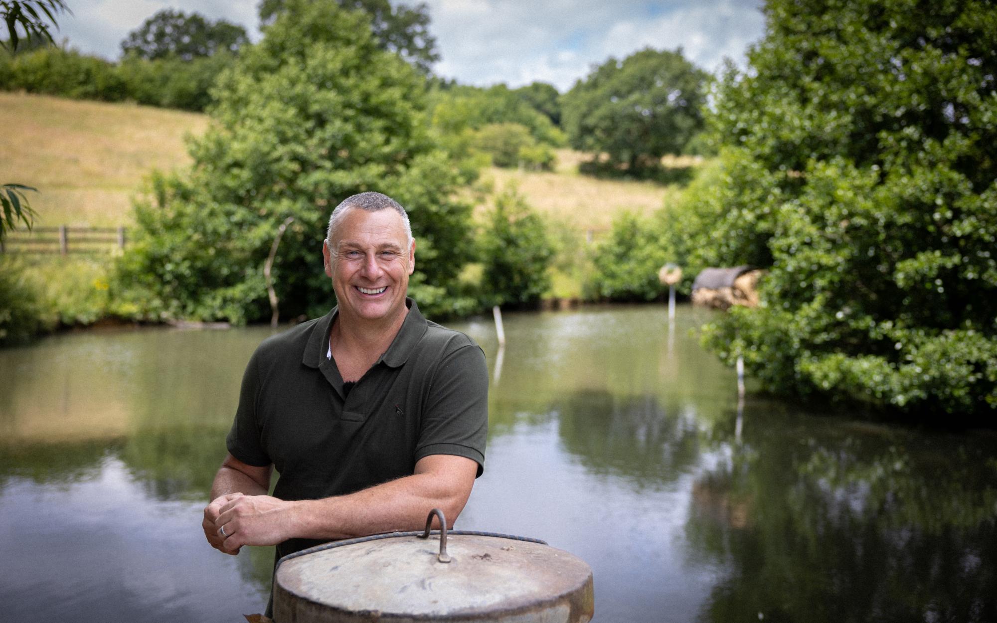 Weathered metal lid with handle on pond edge in Jim Allsop episode