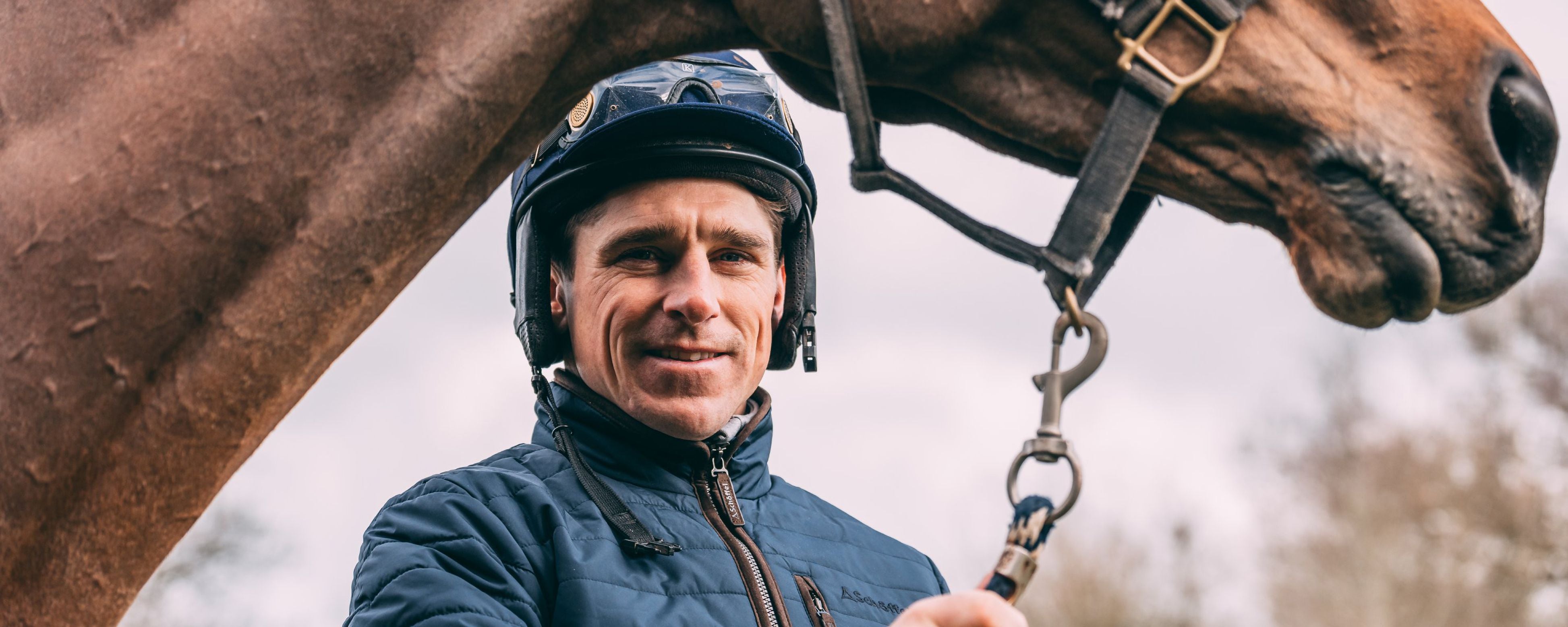 Smiling National Hunt jockey Harry Skelton with brown horse