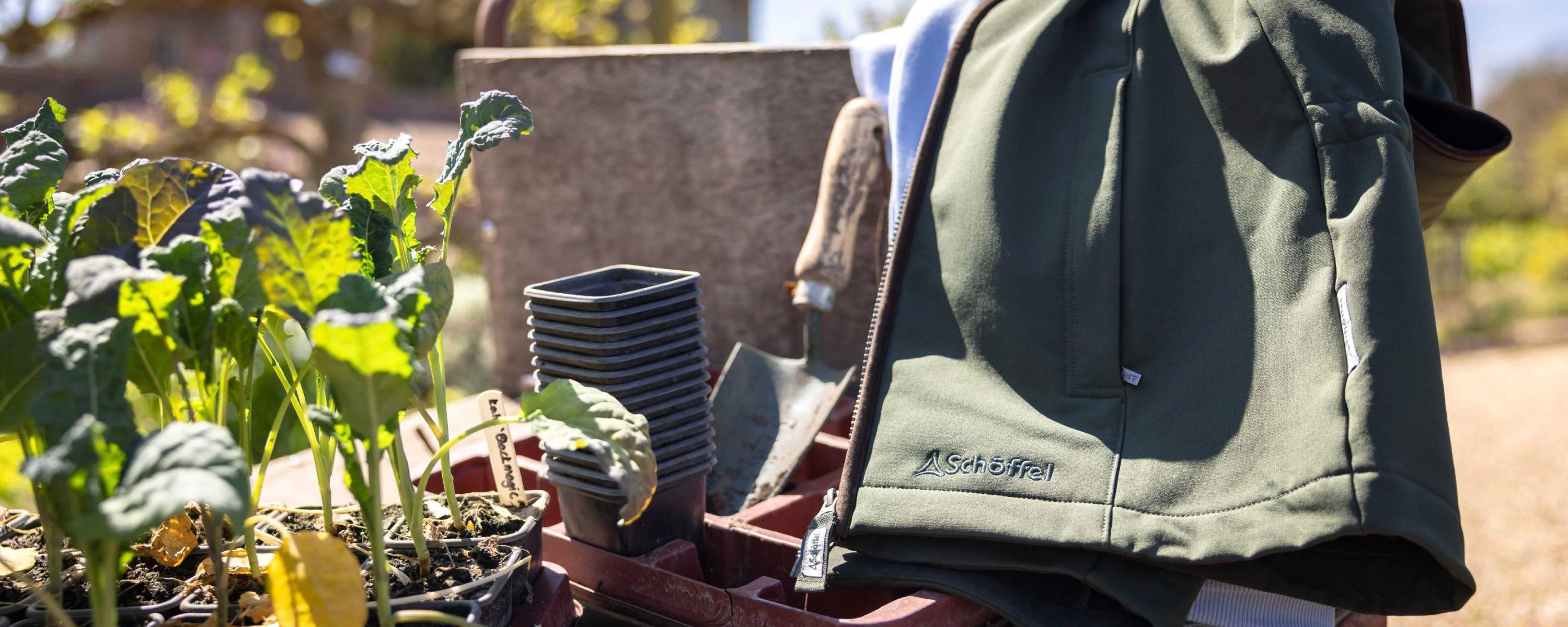 Olive green softshell jacket with subtle chest logo for home gardening