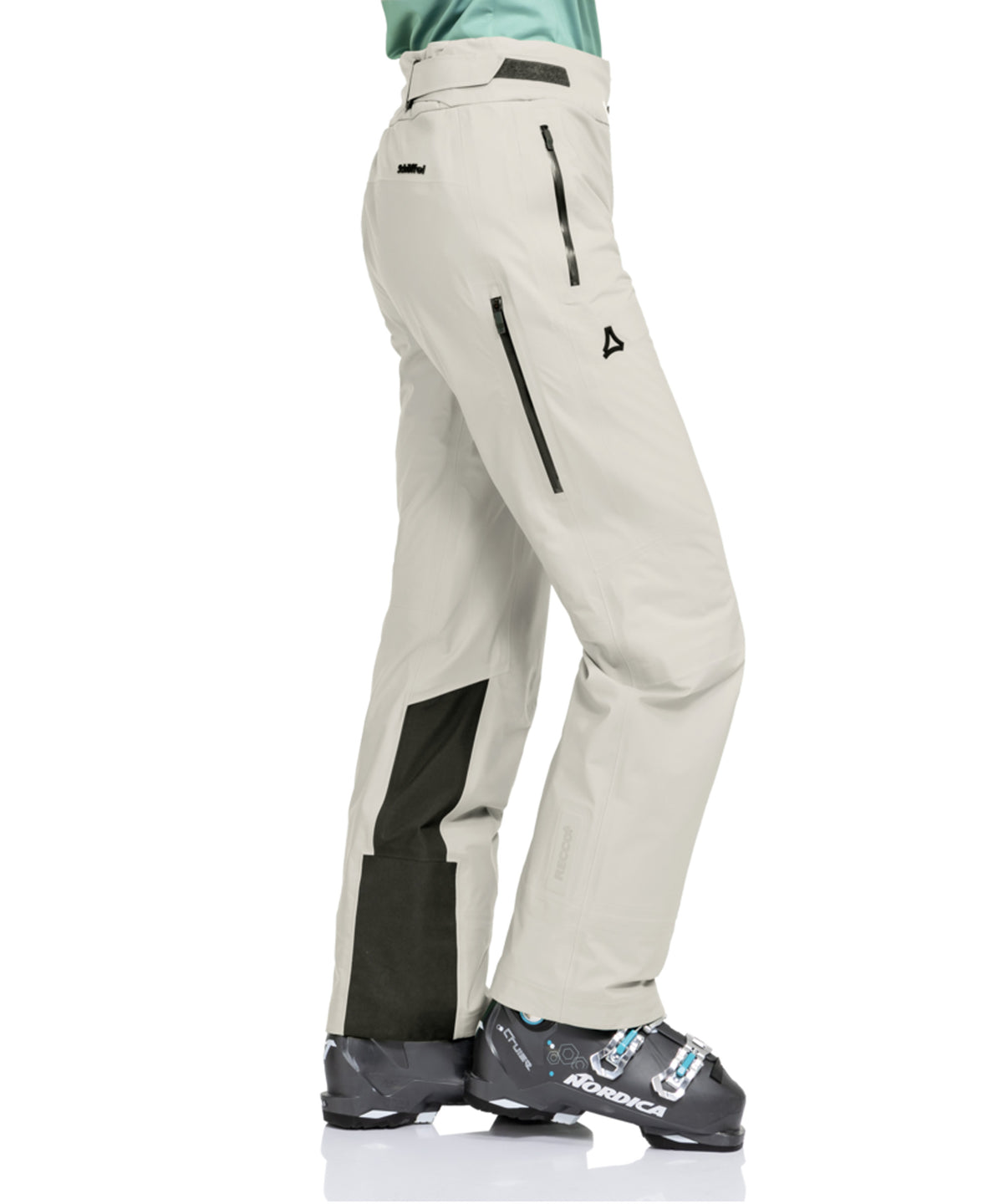 Beige women’s lufeld ski pants with black panel accents and zipper details designed for nordic