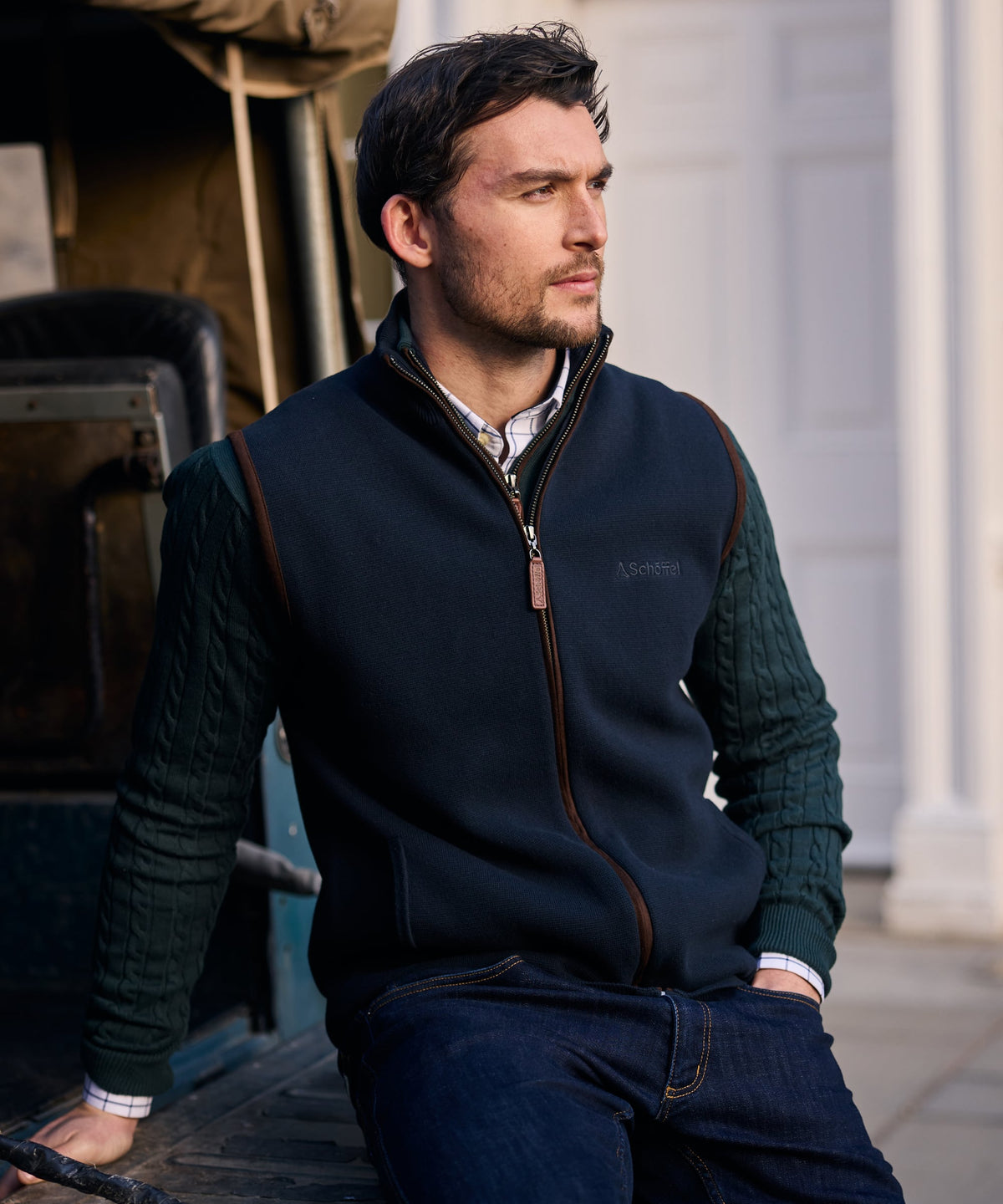 Navy blue fleece marlow gilet with brown leather trim and subtle embroidered logo on the chest