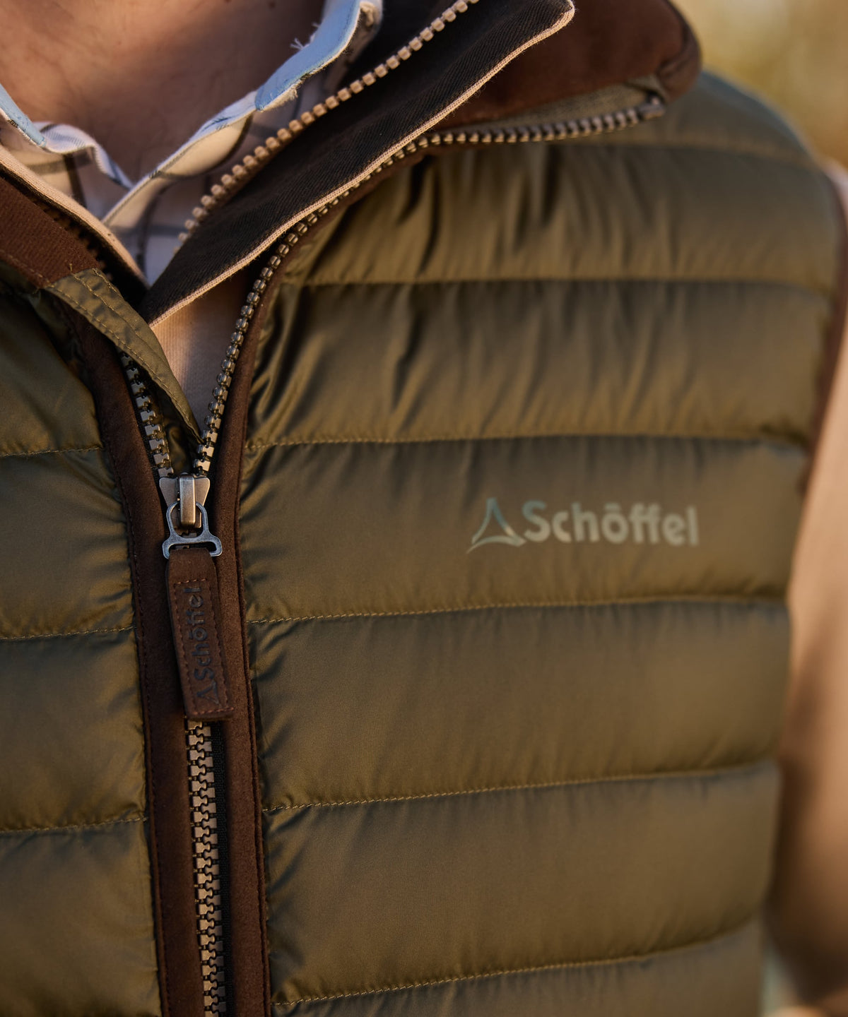 Olive green bowden down gilet quilted puffer vest with brown leather trim and schoffel logo on chest