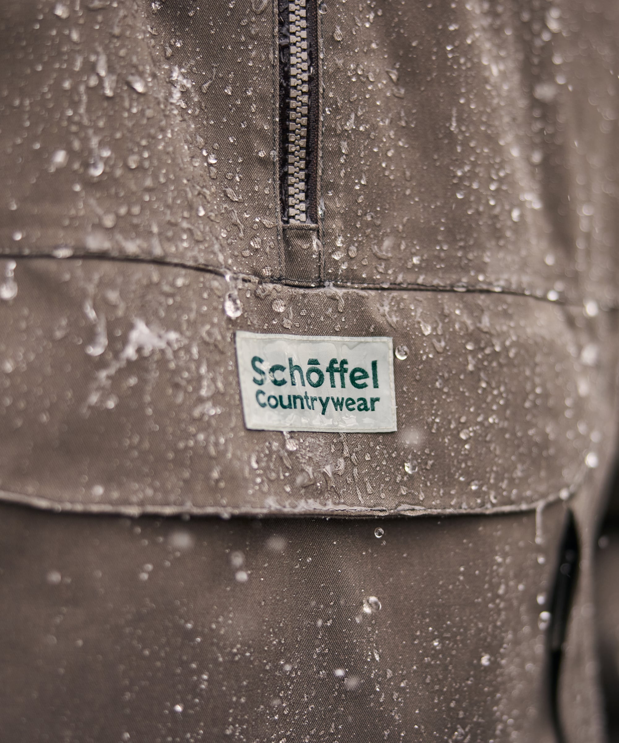 Close-up of a Schöffel Countrywear label on a rain-soaked jacket.