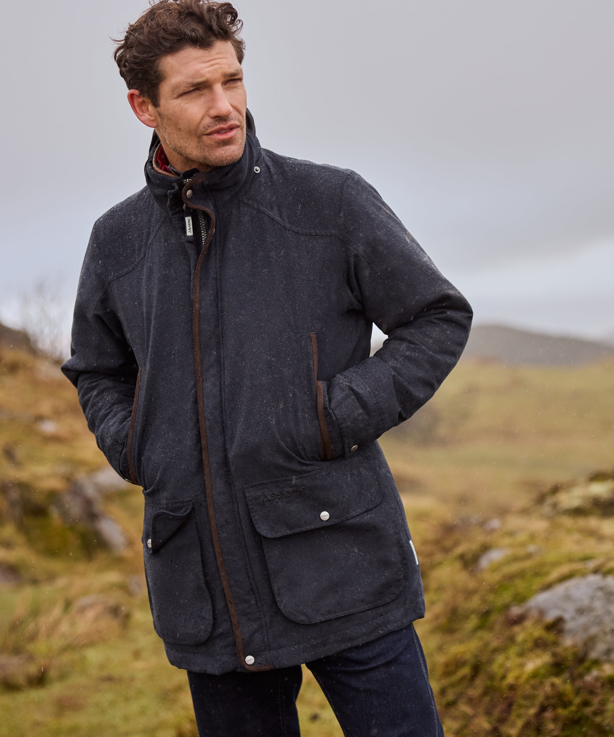 Man wearing a dark jacket in a natural outdoor setting