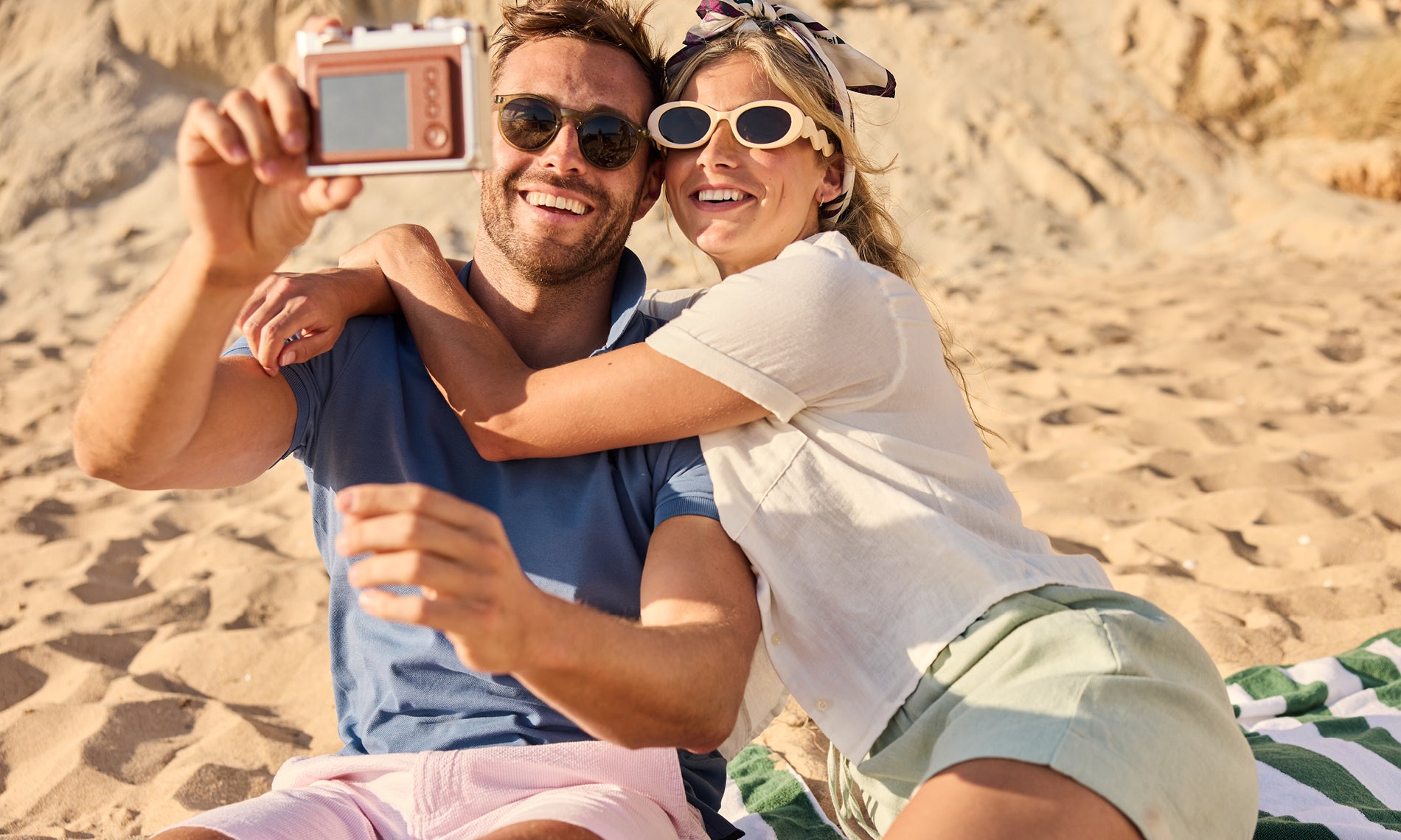 Couple taking a selfie on a sandy beach