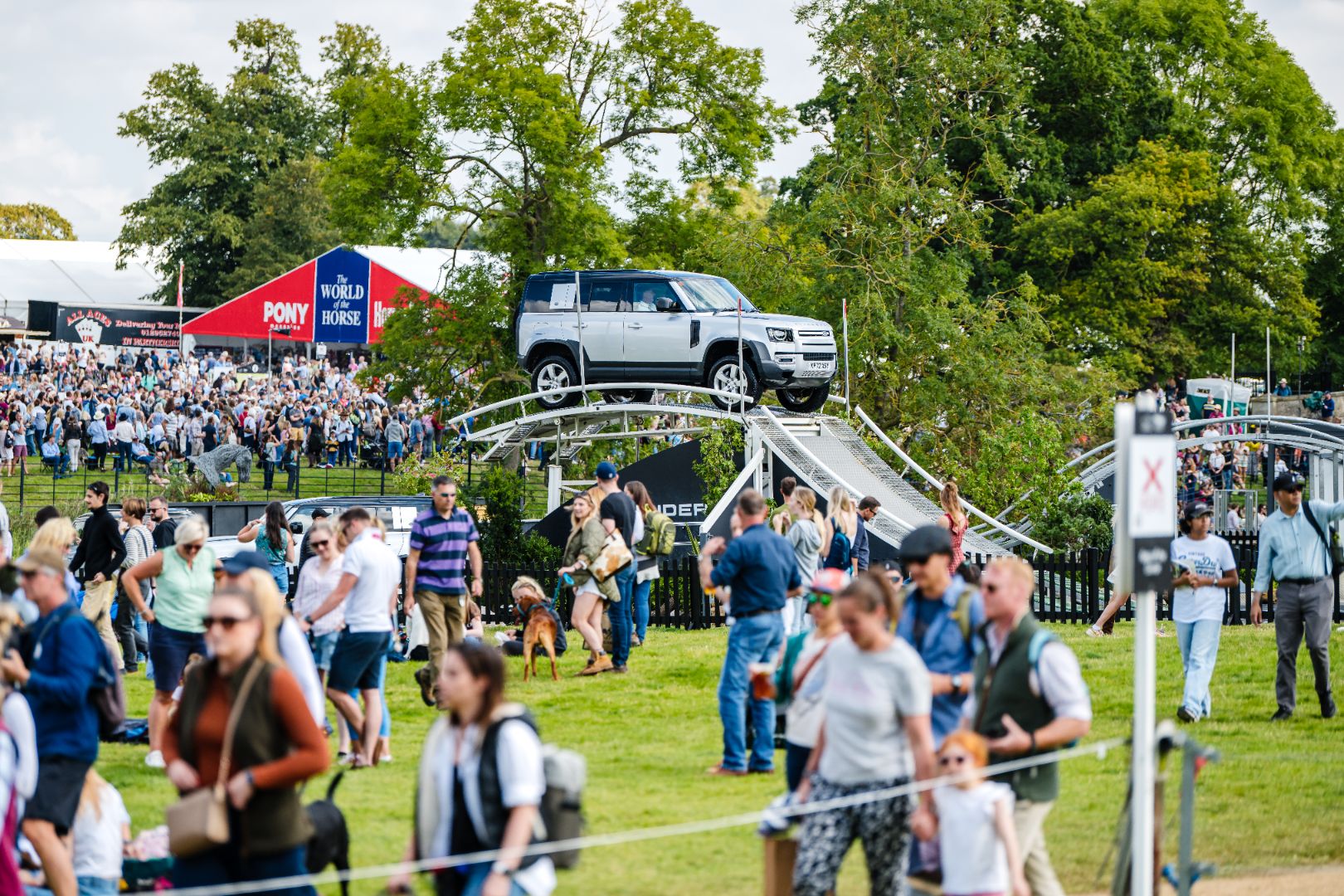 Rows of stands and crowds of people at Burghley Horse Trials.