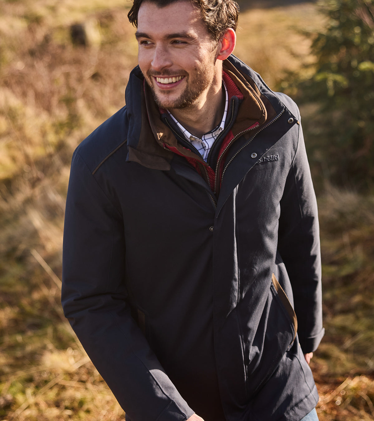Man wearing a navy jacket in a natural setting
