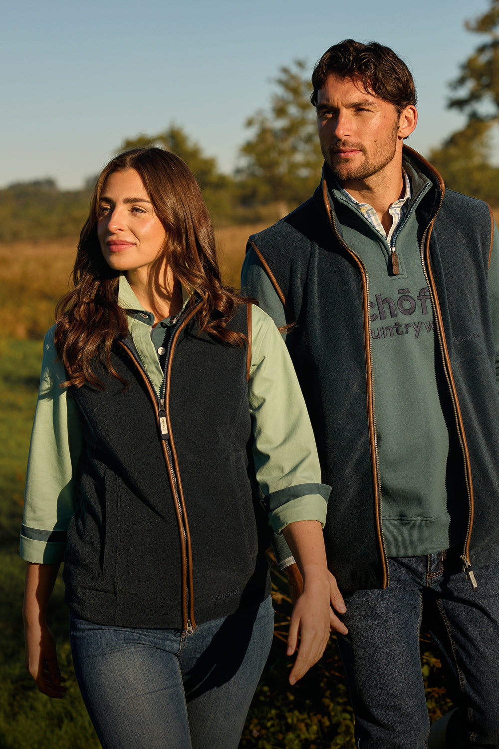 Two people wearing matching outdoor fleeces in a natural setting