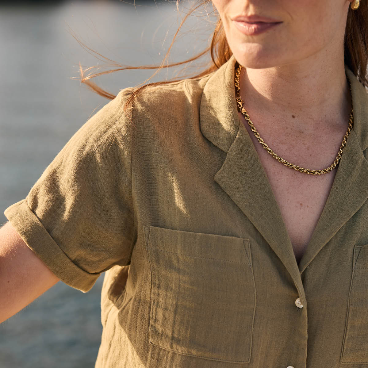 Woman wearing a green shirt with a blurred background