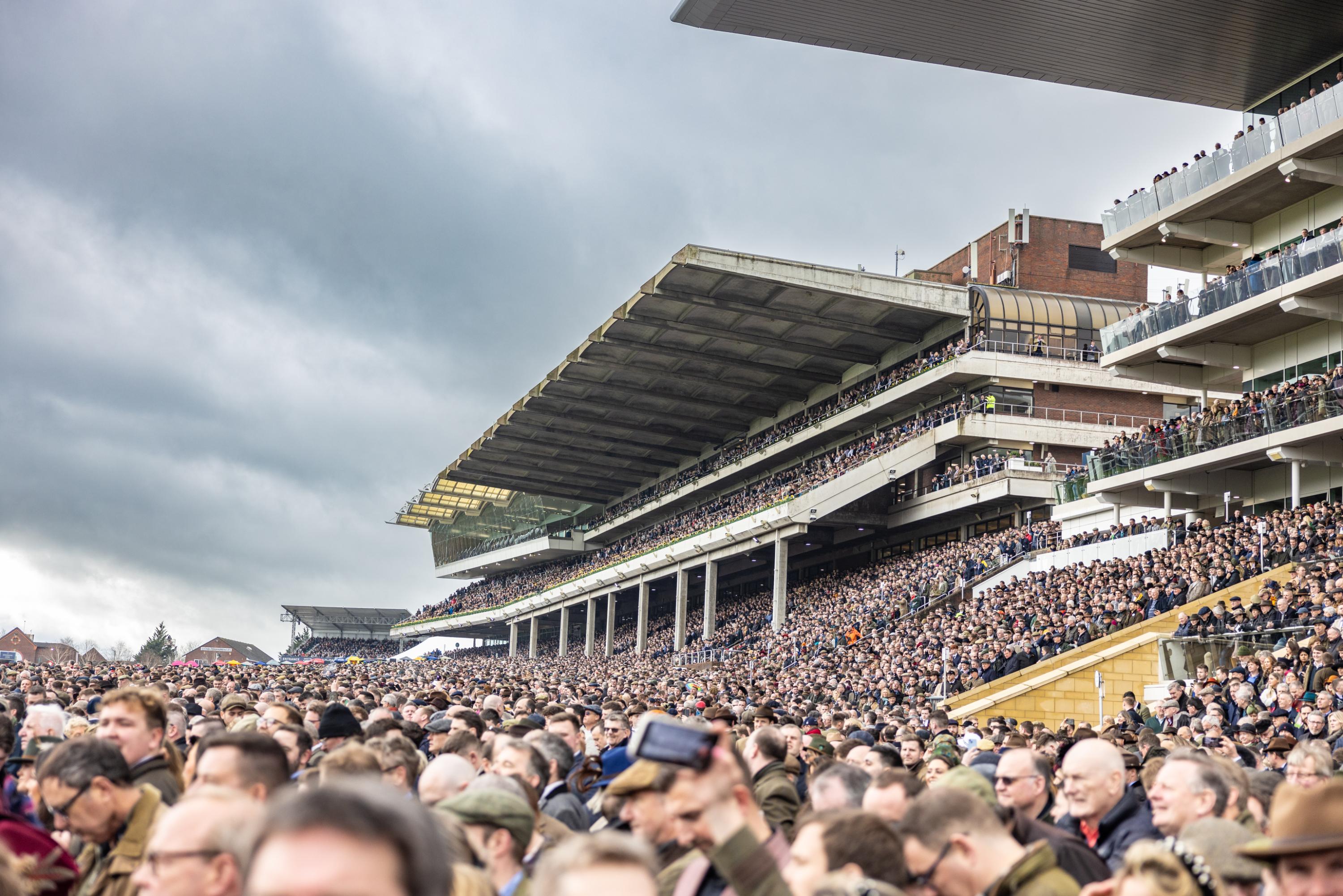 Stands full of people at a racecourse.