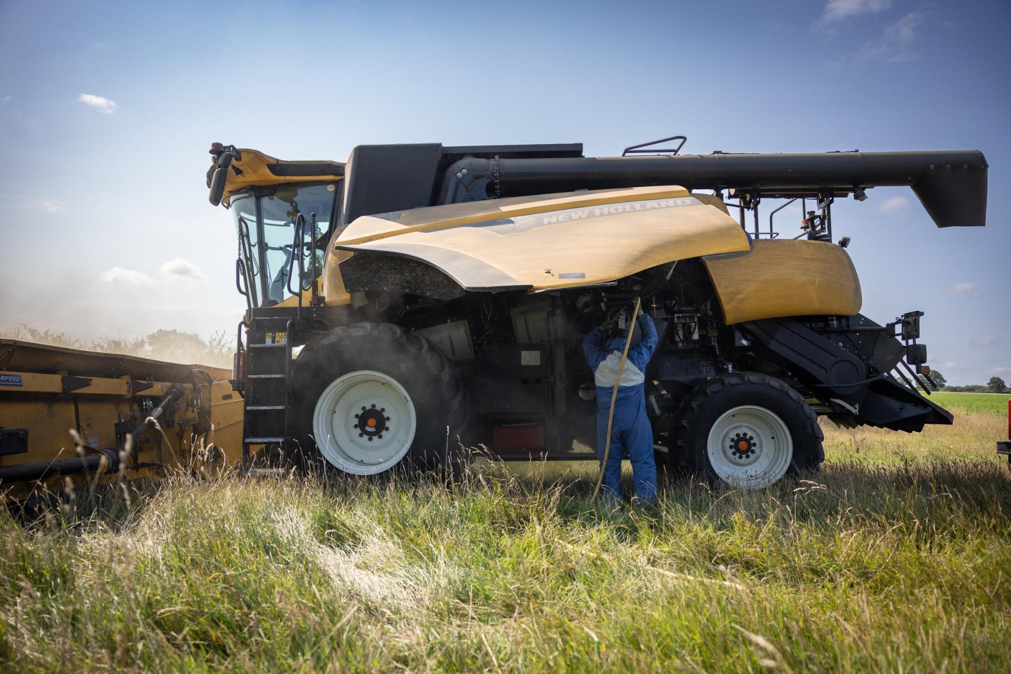 Harvester in a field with a person operating it