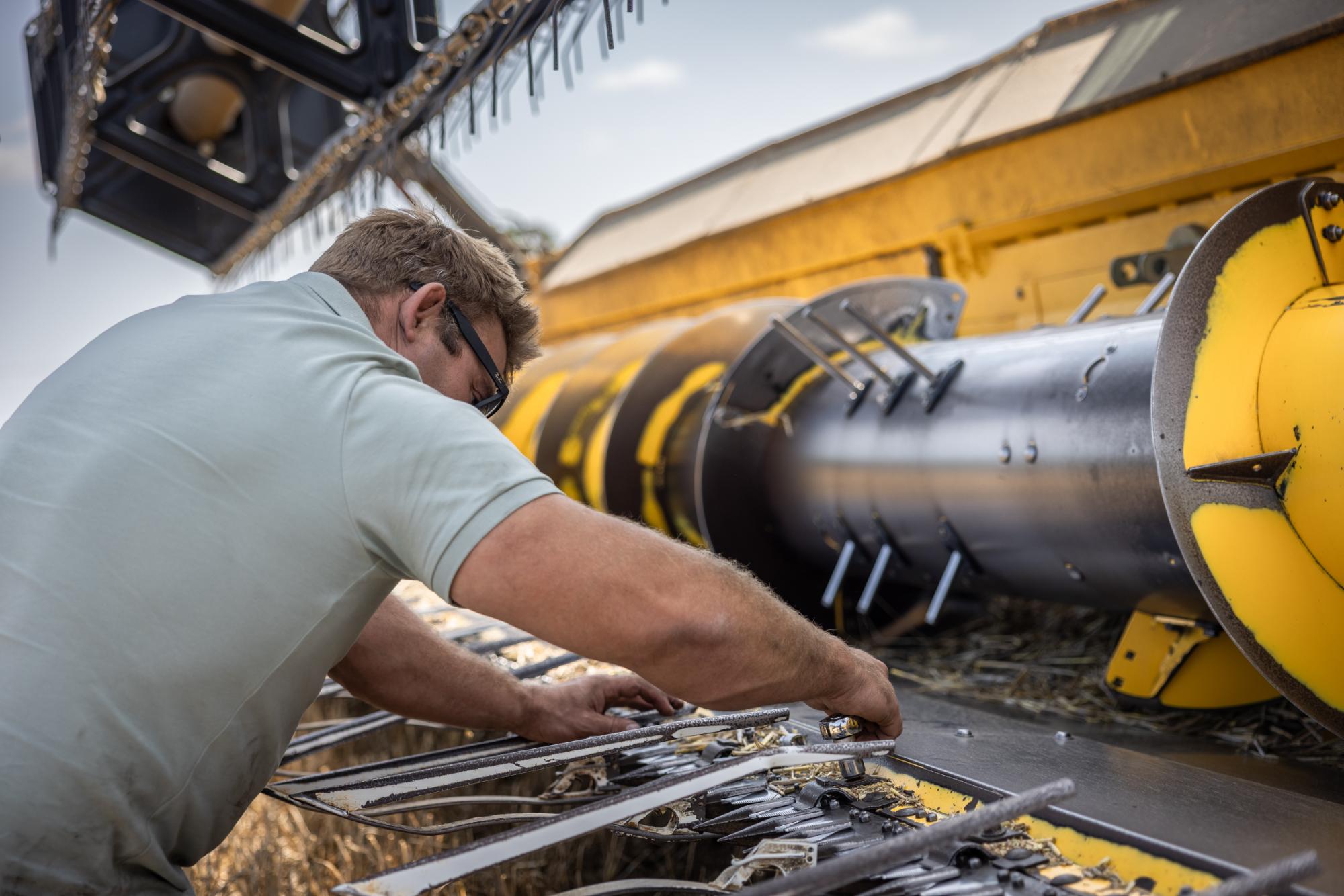 Person working on a large piece of machinery with a blurred background