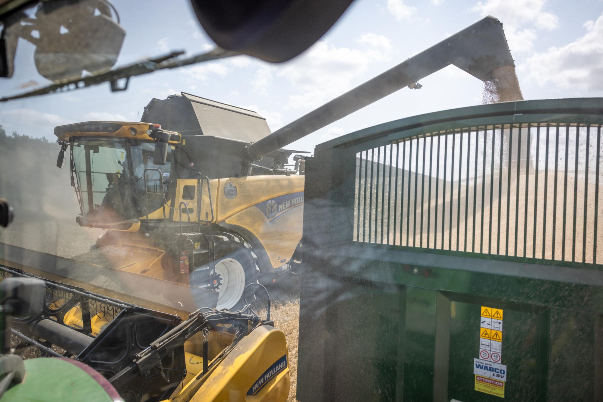 Harvester in a field with a clear sky