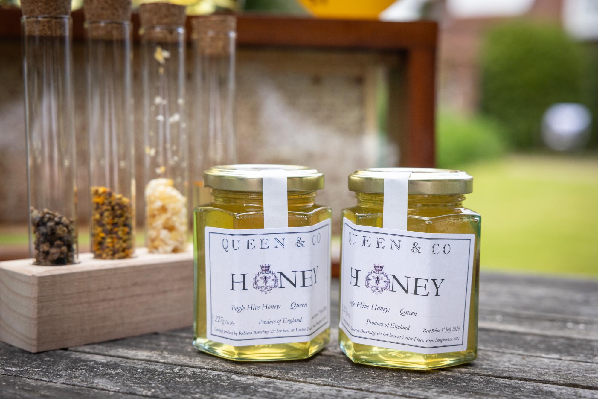 Jars of honey on a rustic table.