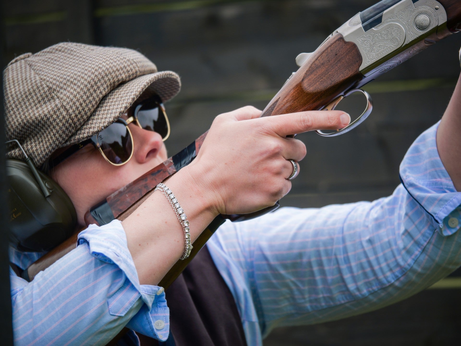 Person holding a shotgun with a blurred background