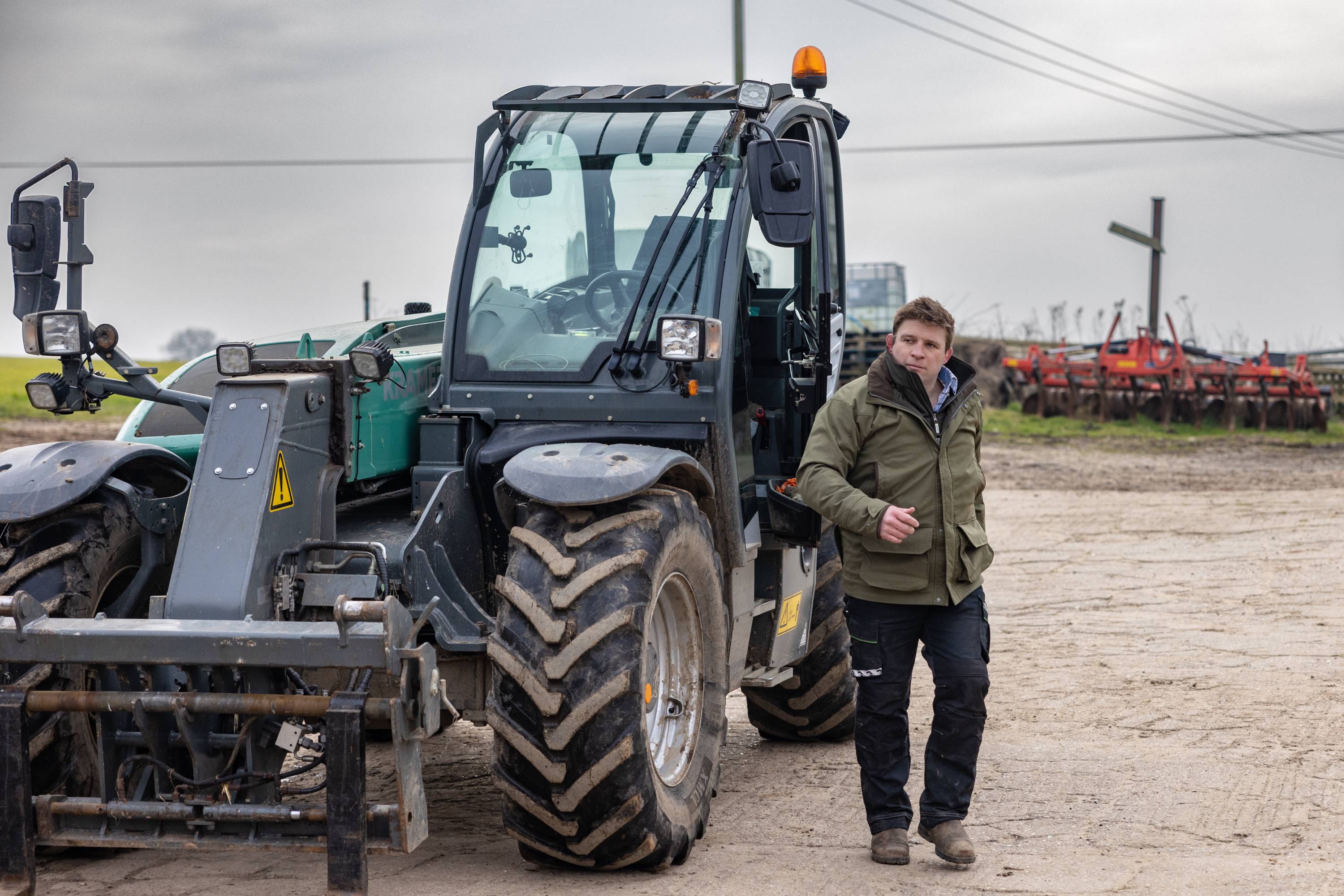 A person standing next to a tractor
