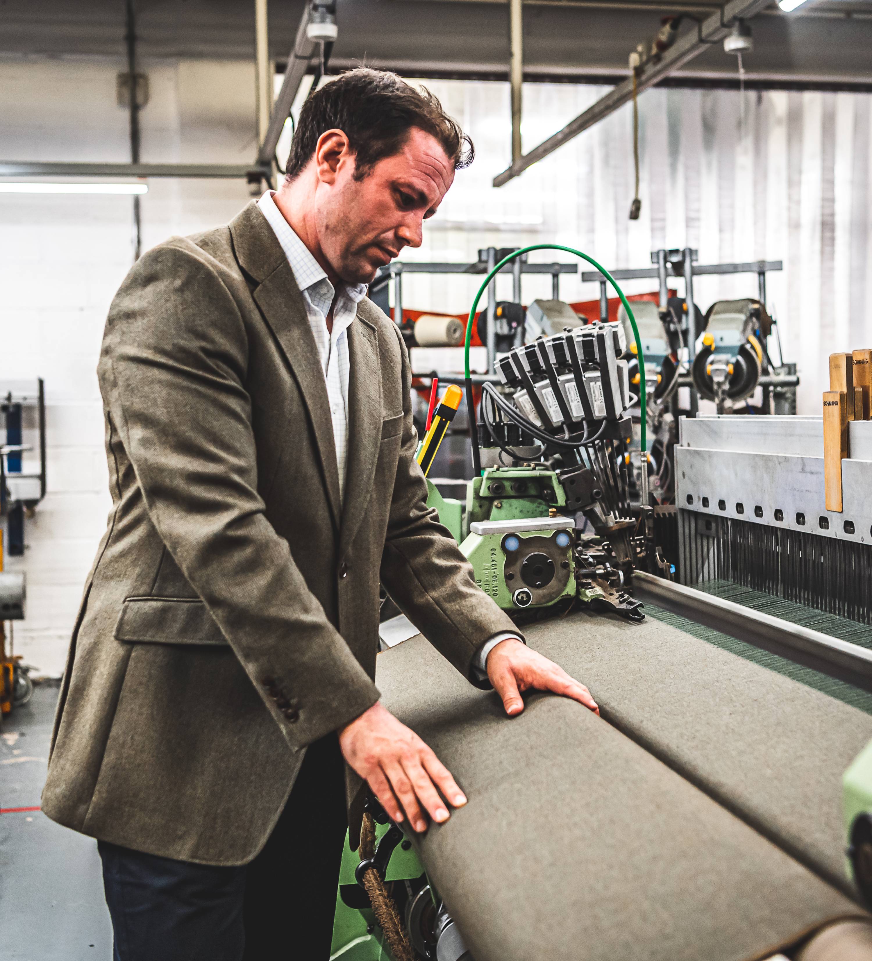 An image showing the inspection and quality control process of making tweed.