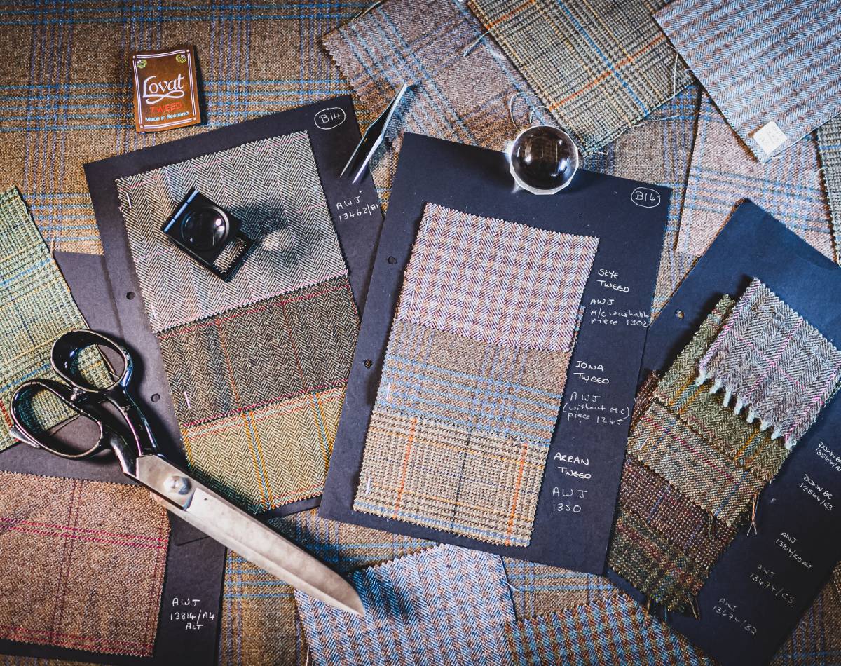 An image showing fabric samples laid out with scissors and other materials.