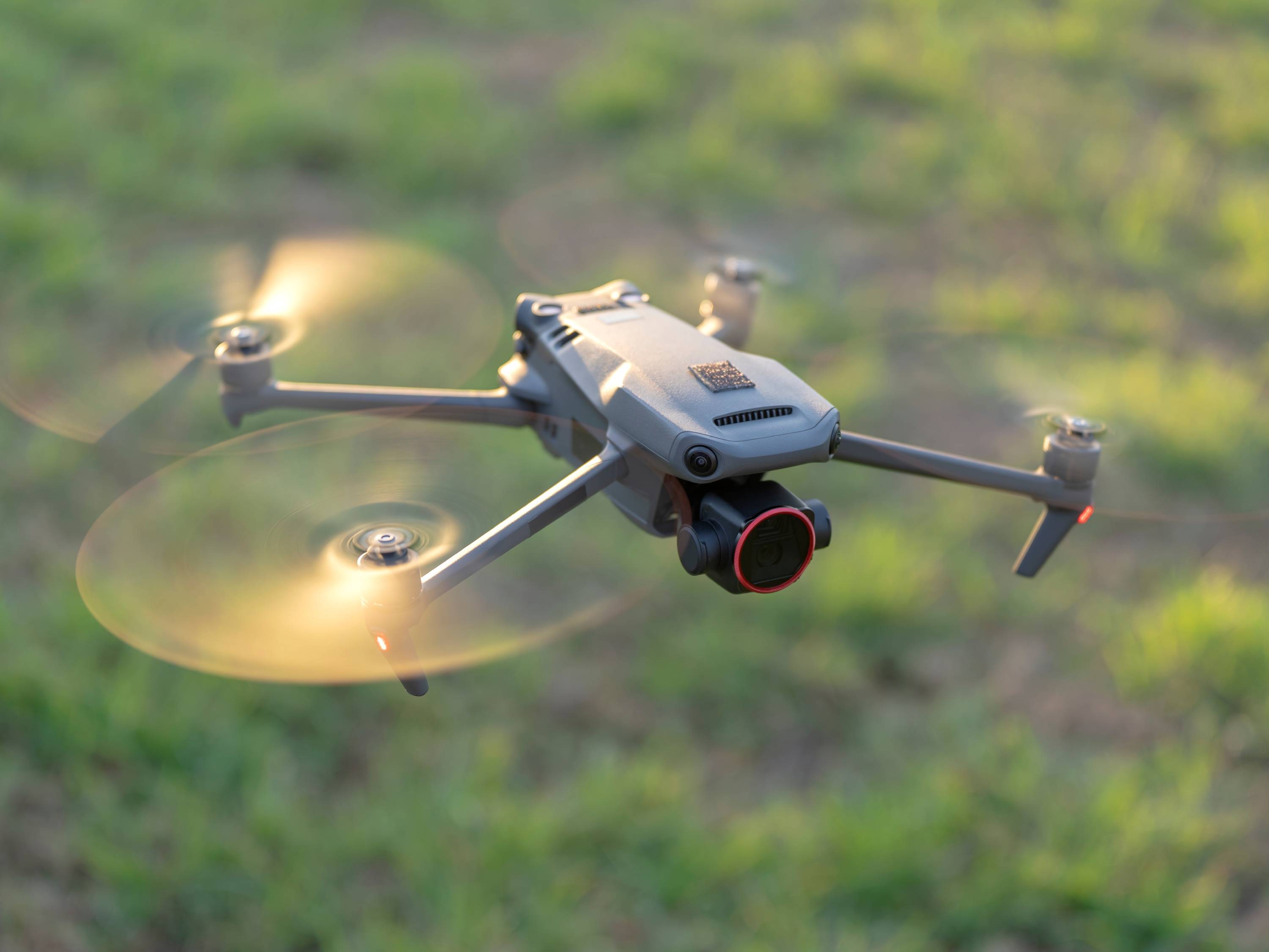An image of a drone hovering over grassland.