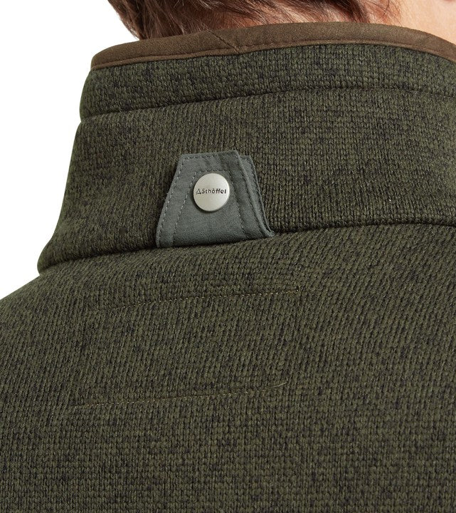 Close-up of a green fleece gilet with a Schöffel branded popper on the collar.