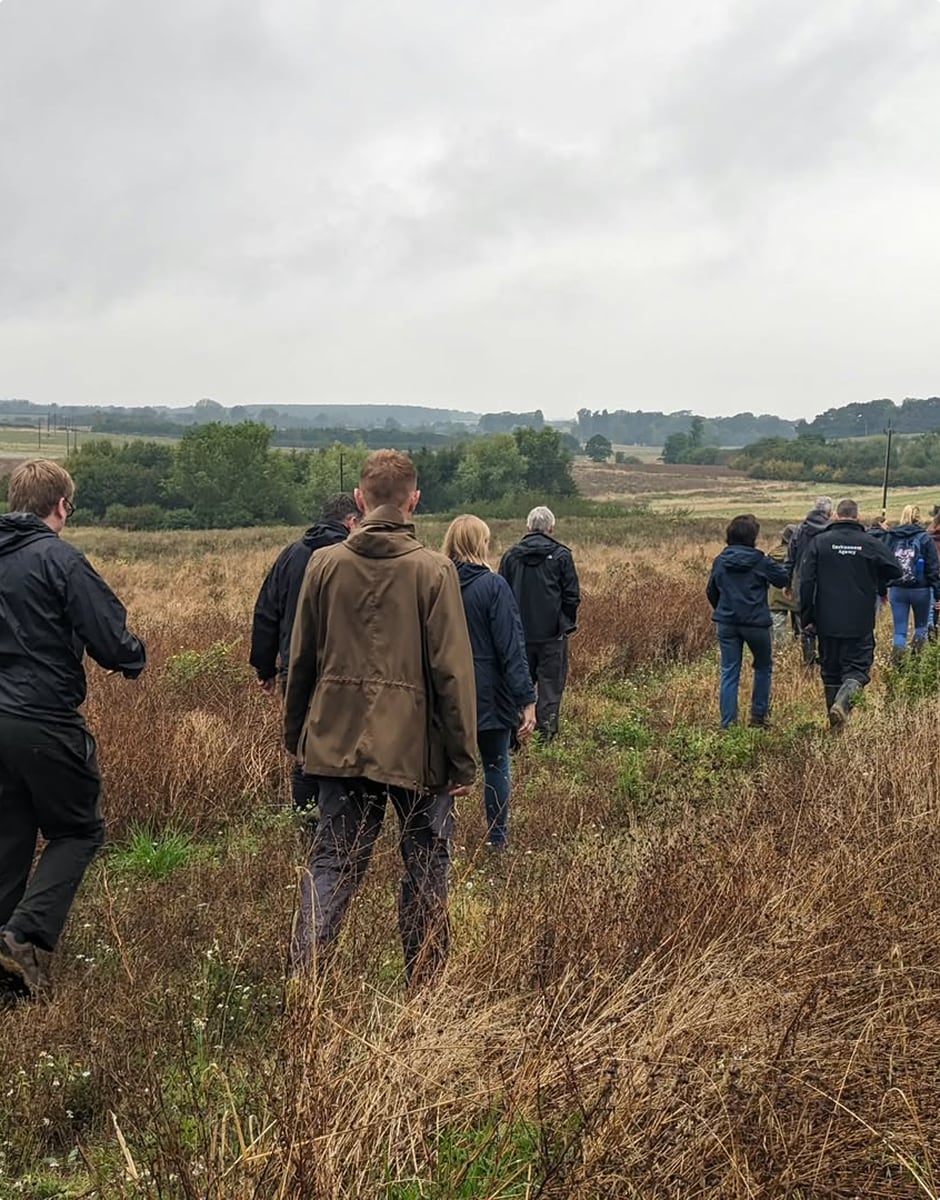 People walking in a field in the countryside