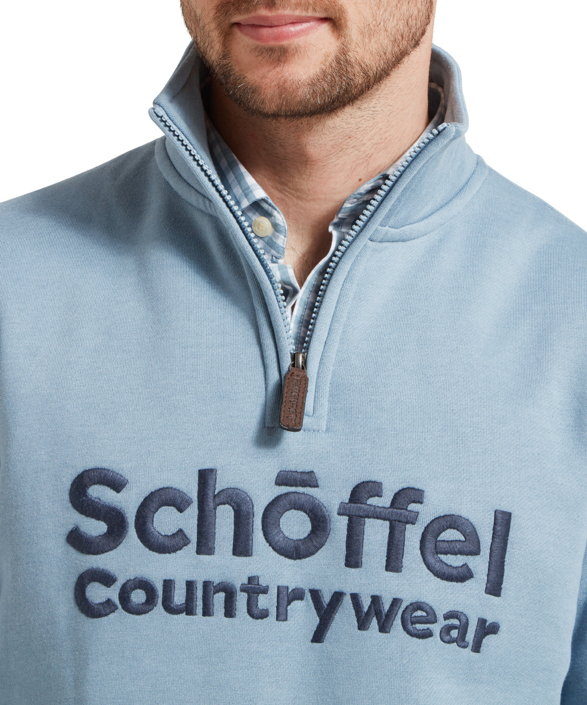 Model wearing the Schöffel Bude Sweatshirt in Blue, brown leather zipper pull