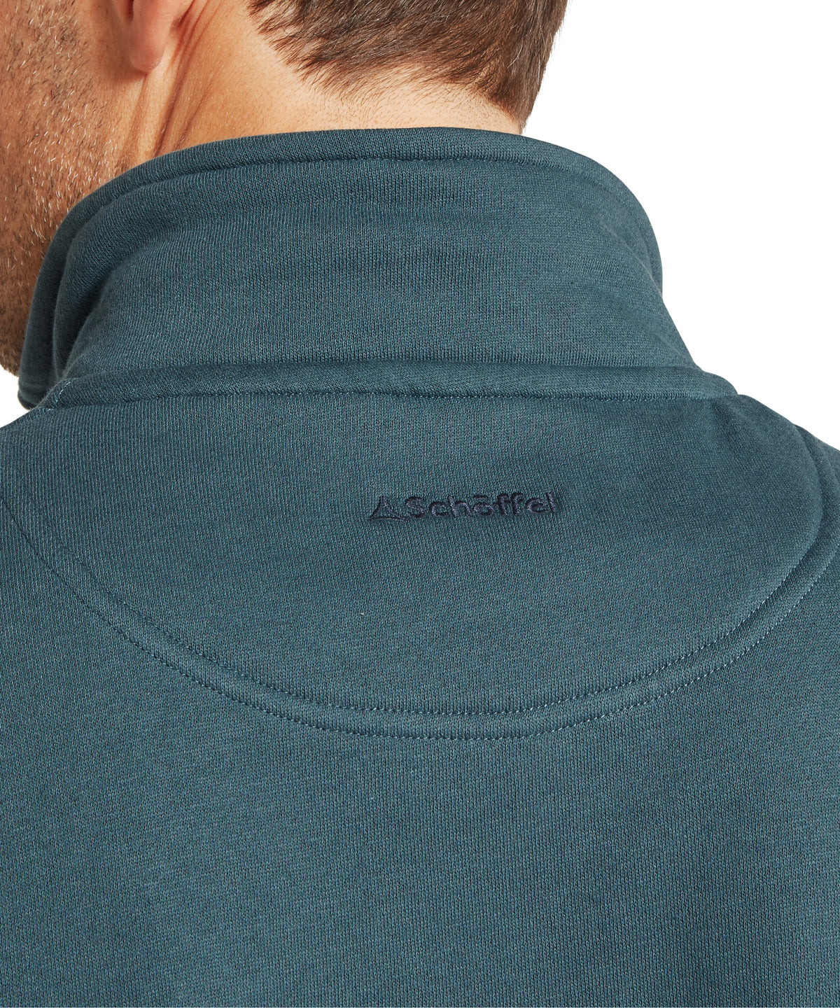 Back view of a teal textured knit half zip fleece jacket with subtle embroidered logo on collar