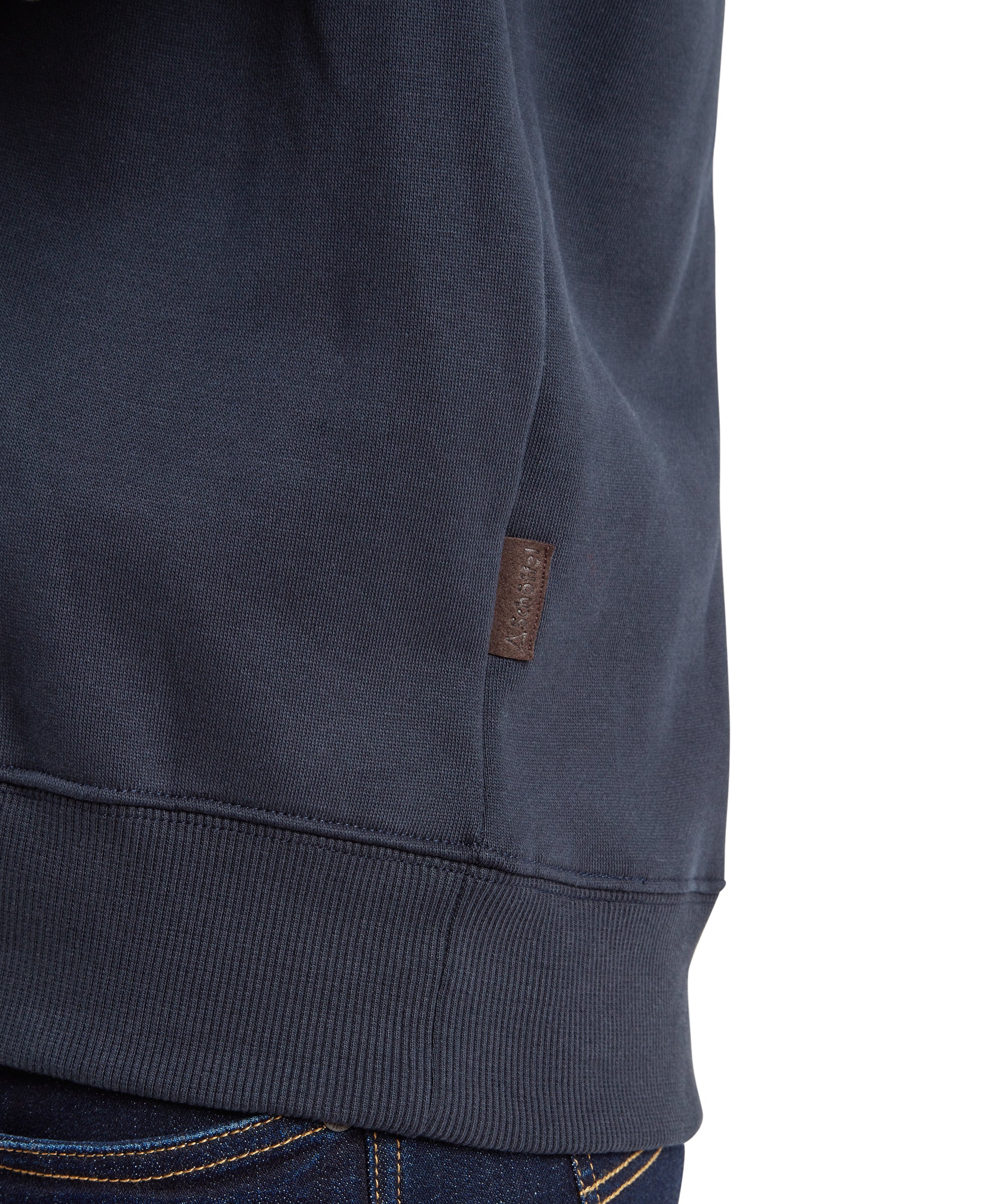 Dark blue knit quarter zip sweatshirt with ribbed hem and small brown leather brand tag on side seam