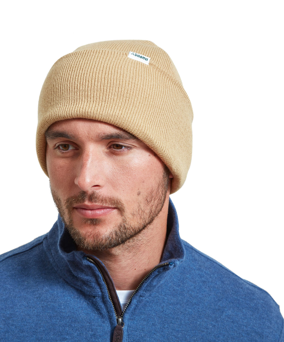 Beige ribbed knit Buxton beanie with a small white label in front made from soft oat-colored
