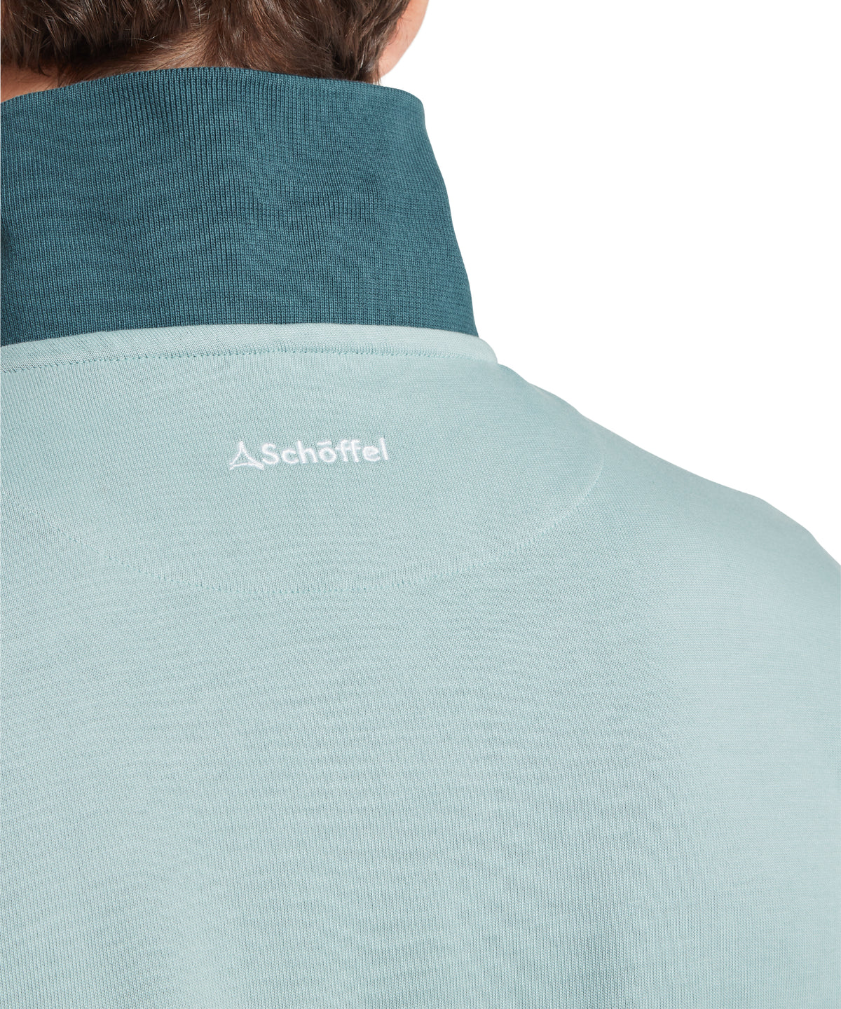 Model wearing the Schöffel Exmouth Heritage 1/4 Zip in Blue, schöffel logo