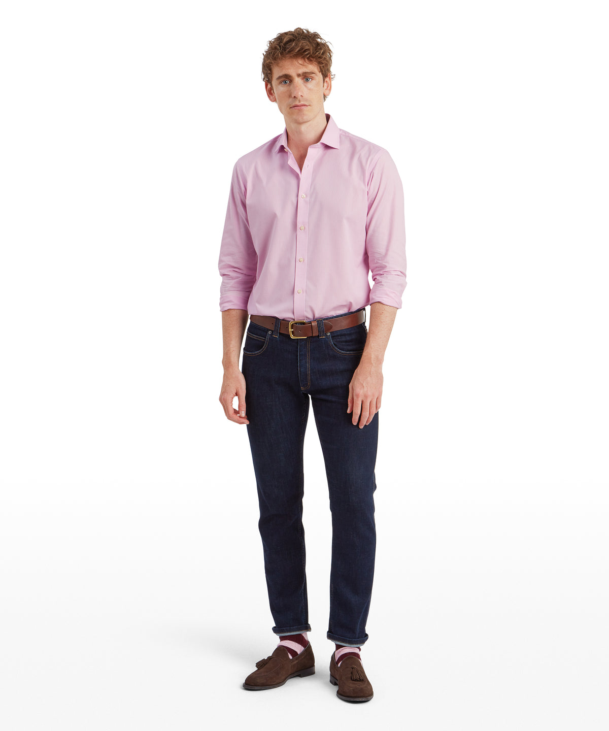 Man wearing light pink micro check Greenwich tailored long-sleeved button-down shirt with rolled-up