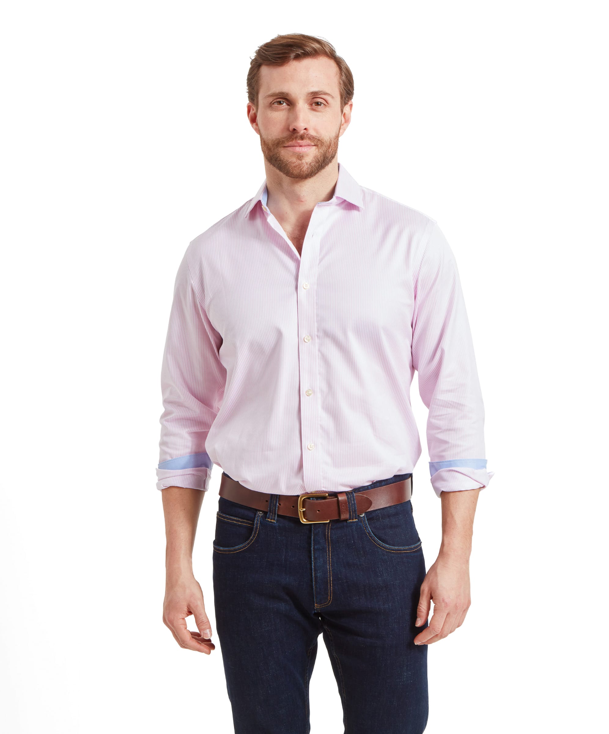 Man wearing the Schöffel Greenwich Tailored Shirt for Men in Pink Stripe, standing with hands clasped.