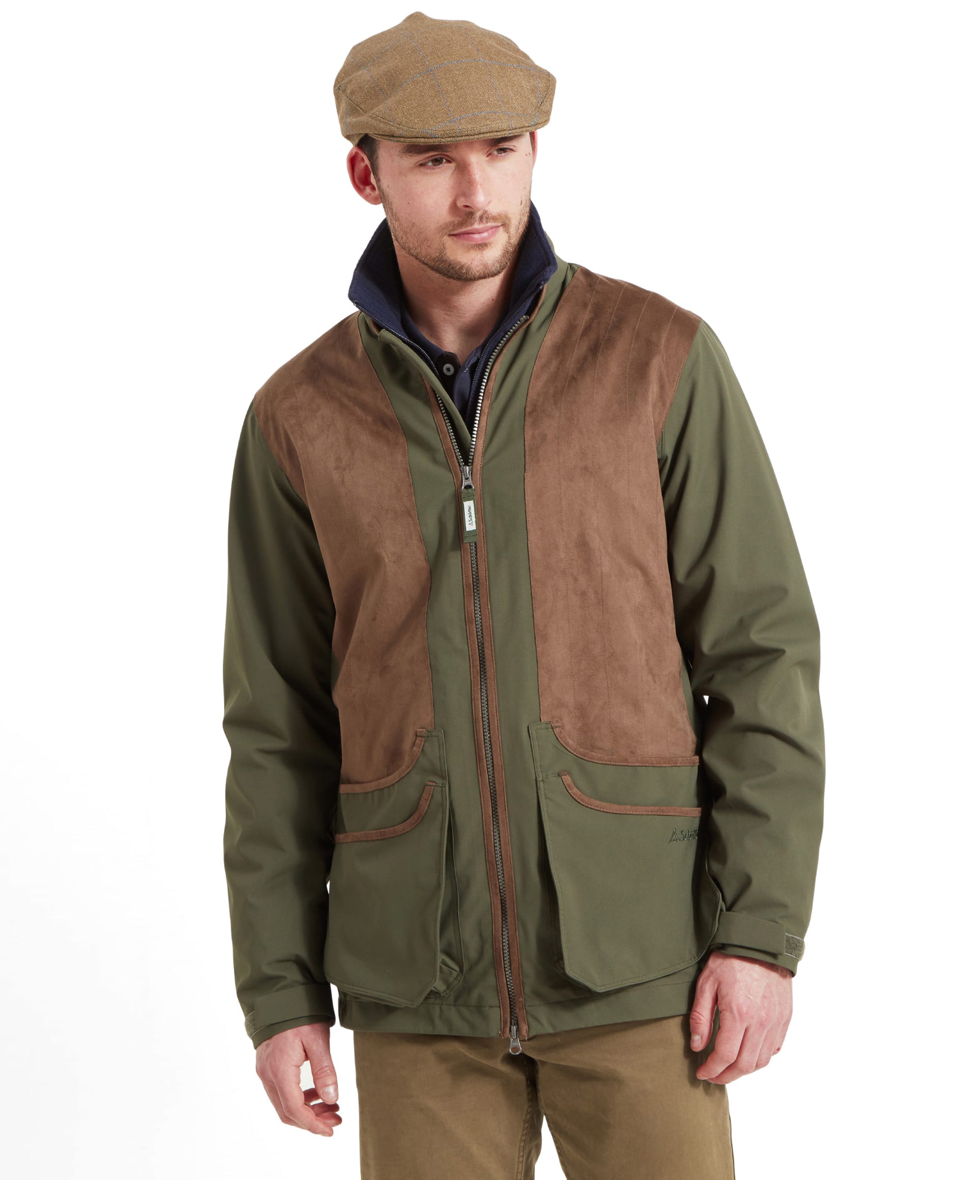 Schöffel Men's Grimsthorpe Clay Shooting Jacket in Green — front view showing full-length zip, contrast suede shooting patches, deep cartridge pockets and Schöffel branding, styled with a tweed flat cap