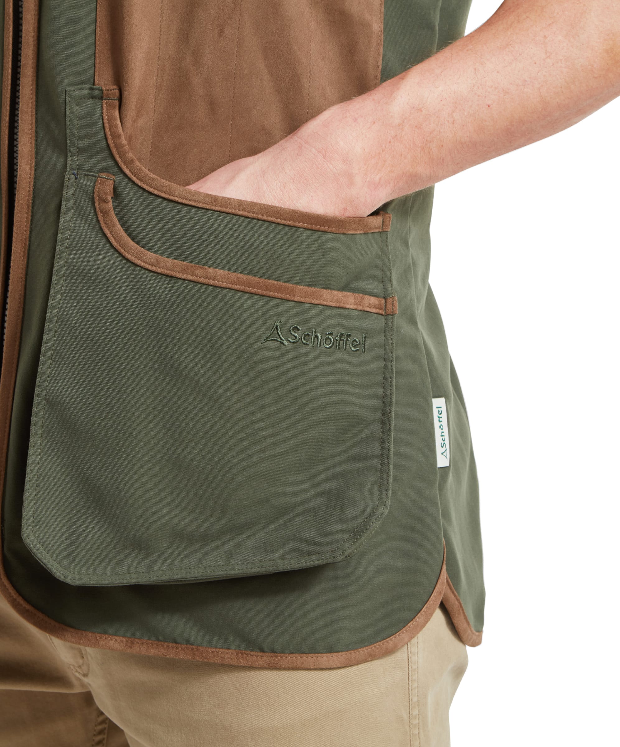 Schöffel Men's Grimsthorpe Clay Shooting Vest in Green — close-up of deep cartridge pocket with suede trim edging, Schöffel embroidered logo and woven label detail