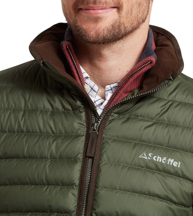 Green puffer jacket with brown hood and zipper, featuring Schöffel logo.