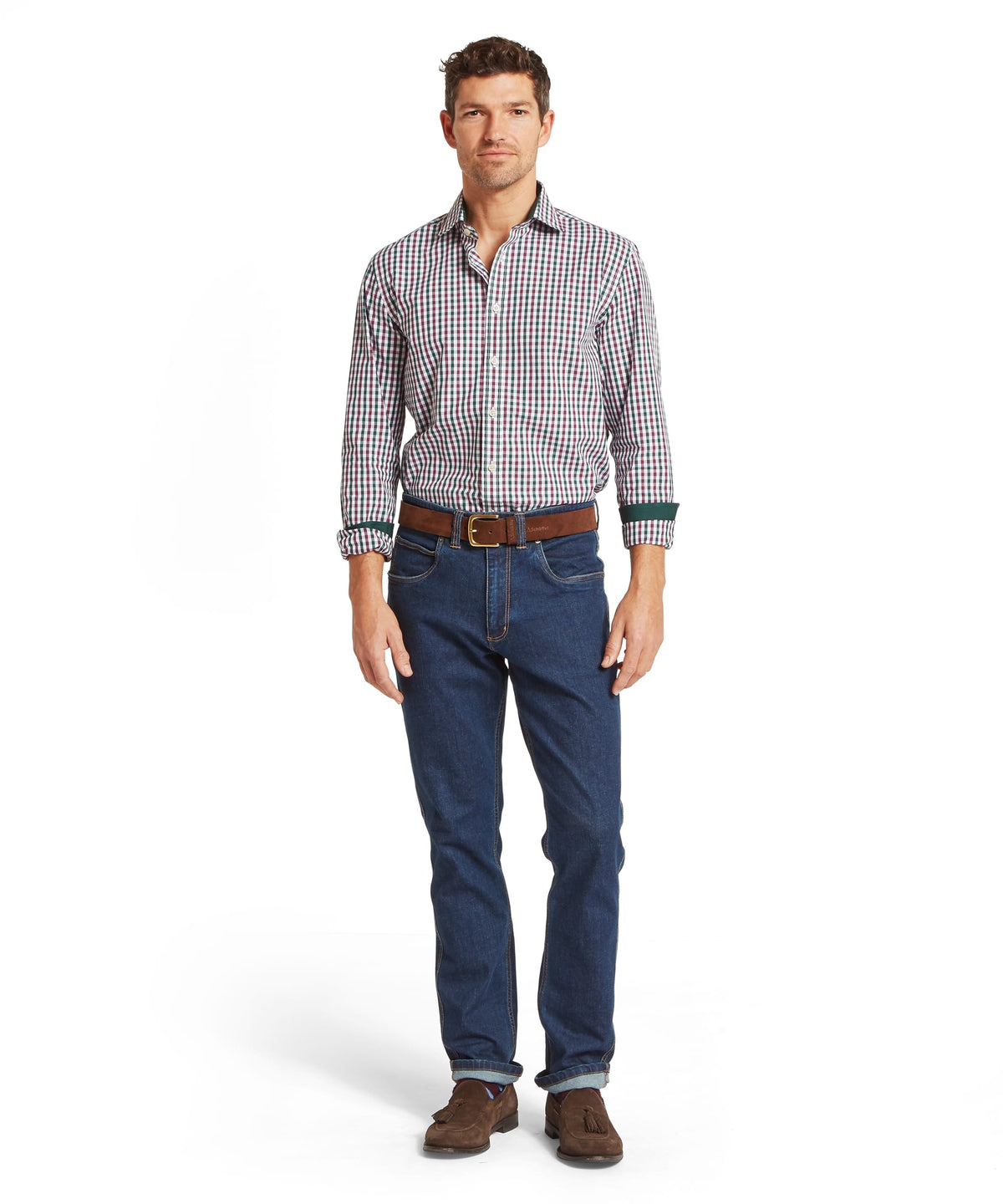 Mens dark blue denim jeans with rolled cuffs and brown leather belt paired with hebden tailored