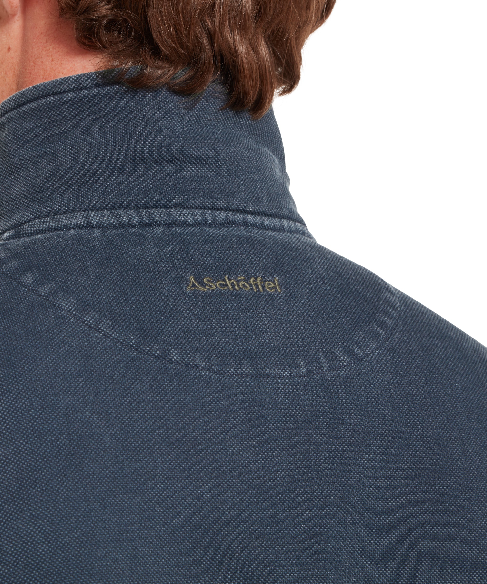 Close-up of a man wearing a two-tone sweatshirt with blue and green colours on a white background