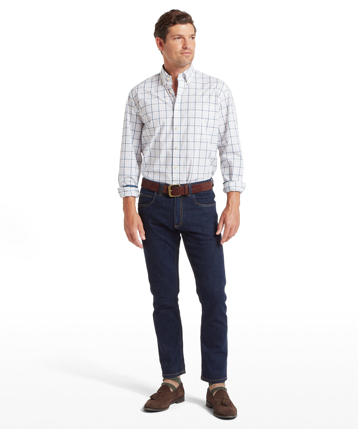 Man wearing holkham classic shirt in deep ocean blue coral peach with rolled sleeves and dark blue