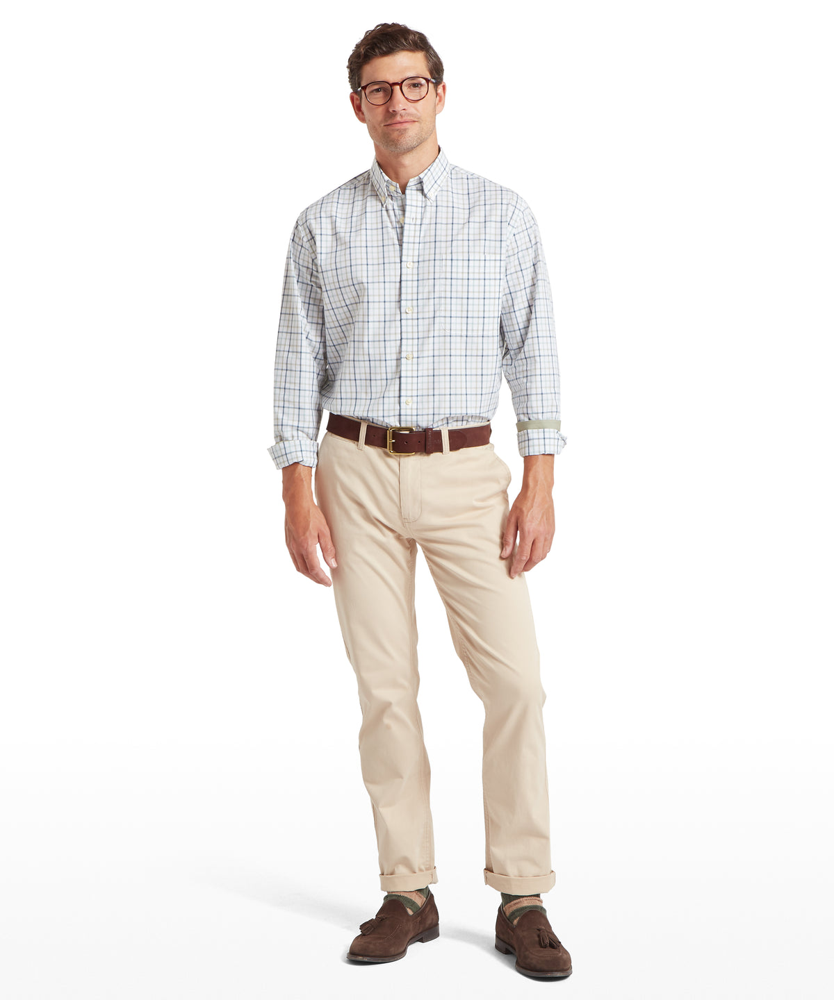 Man wearing holkham classic shirt in deep ocean blue and agave green plaid with beige chinos