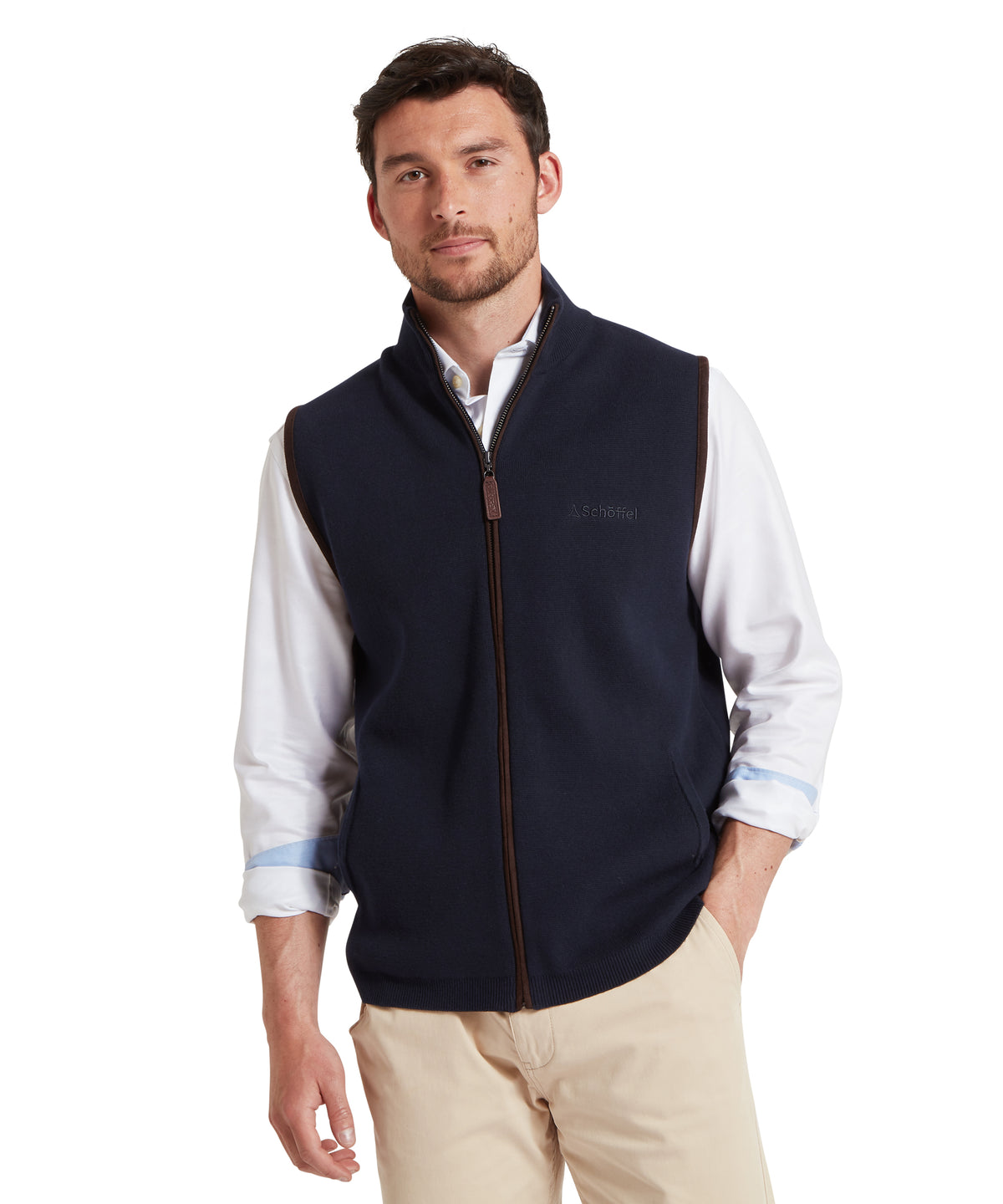 Navy zip-up gilet with brown trim and subtle brand logo designed for layering and outdoor wear