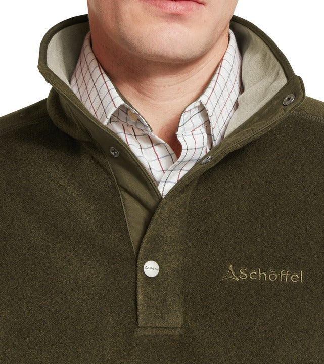 Schöffel Norton men's fleece in green, close-up of high funnel neck with popper button fastening and embroidered logo, worn over checked shirt