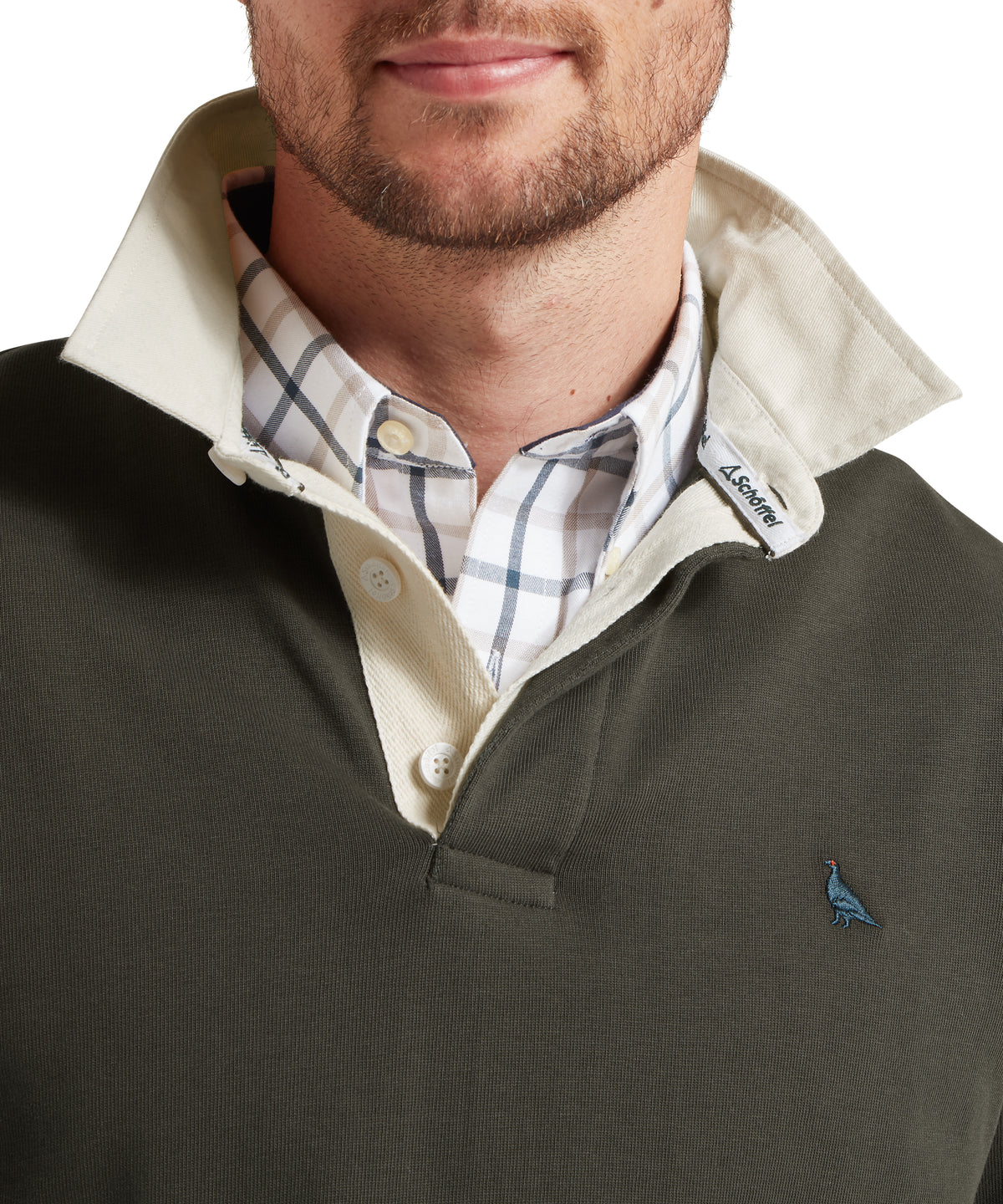 Schöffel's Porthallow Rugby Top in Green, on model, cream collar, and blue bird logo