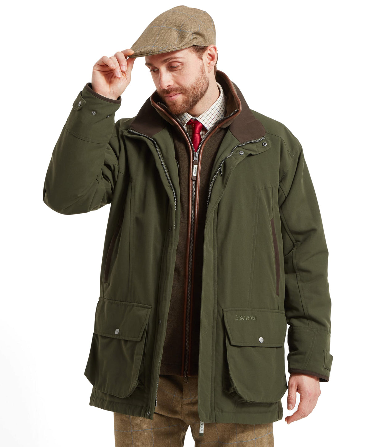 Model wearing the Schöffel Ptarmigan Classic Coat in Green, red zipper accents