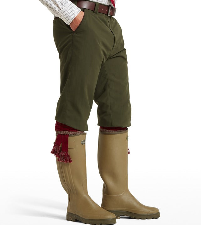 Schöffel Ptarmigan plus twos in green, side profile worn with leather belt, garter flashes and wellington boots