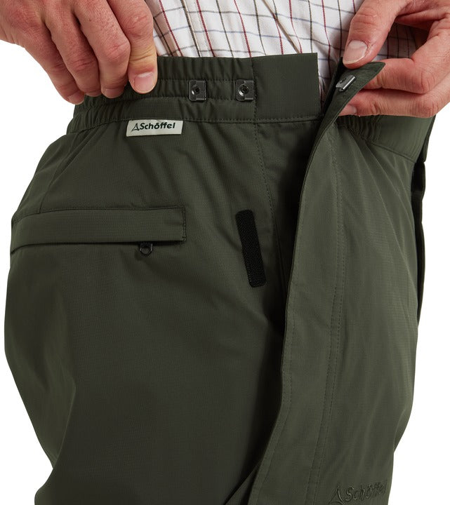 Schöffel Saxby II men's overtrousers in green, close-up of adjustable waistband with popper fastening, hook-and-loop side adjuster and zipped side pocket