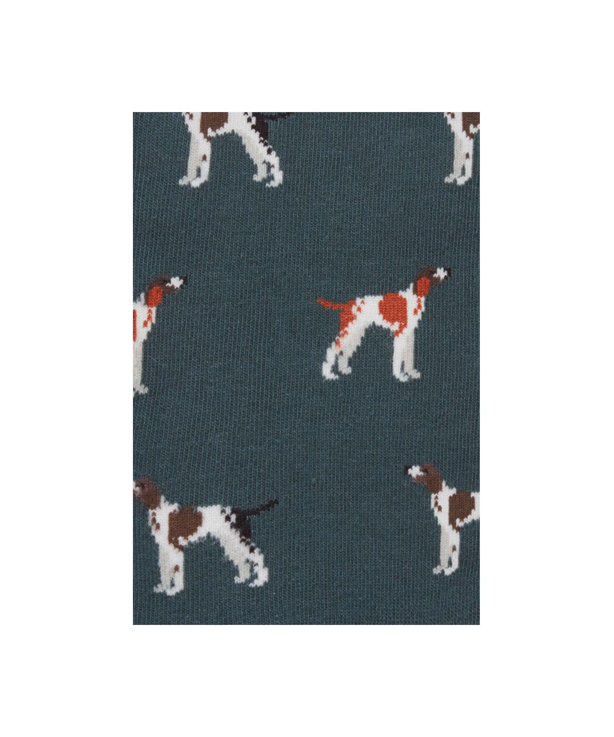 Close up of a sock with dog illustrations on a blue background