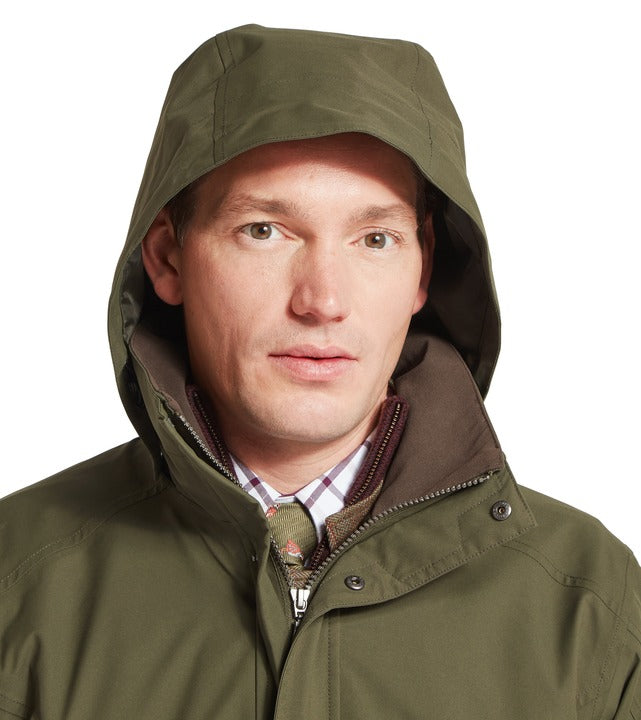 Schöffel Snipe ultralight coat in green, man wearing hood up with contrast collar, styled with checked shirt and tie